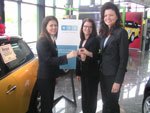 Close up Andraea takes delivery of her Mini Cooper from Laura Rusche and Jamie Bailey of BCG's Chicago Office